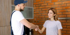 Customer shaking hand with HVAC technician outside