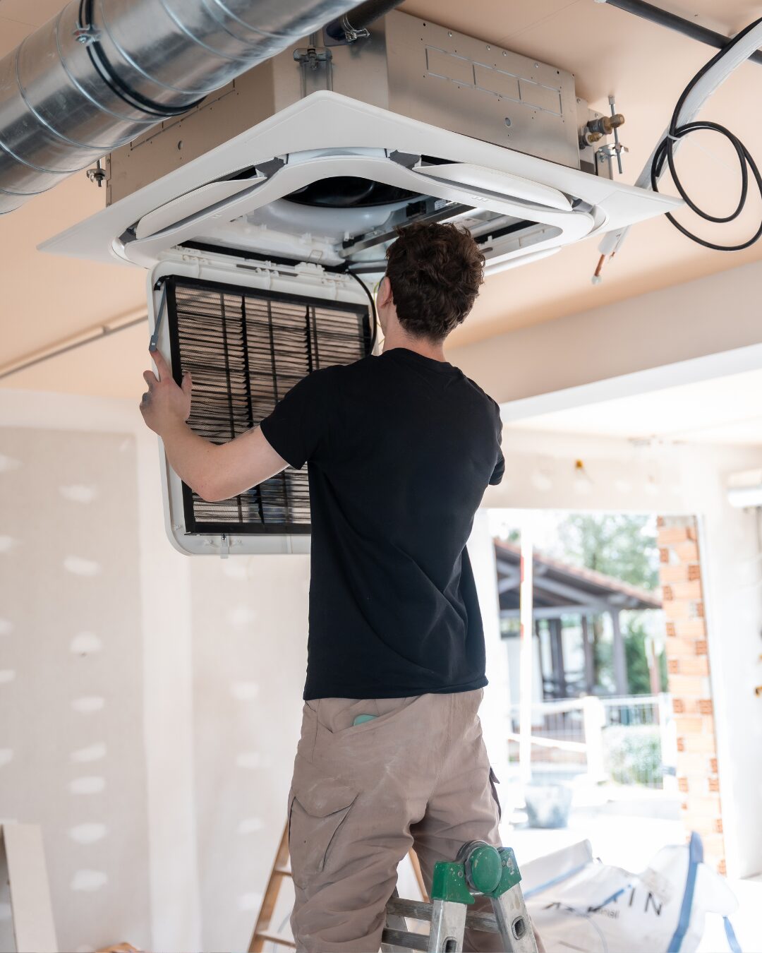 Man performing maintenance on an air filter