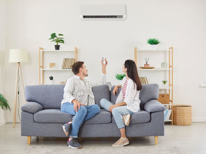 Couple enjoying a newly repaired air conditioner