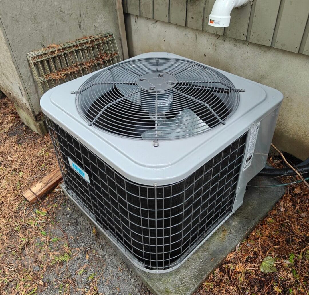 Clean air conditioner unit after being cleaned standing outside house