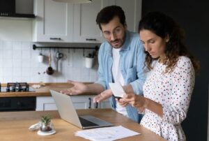 Couple looking at documents and trying to make decision