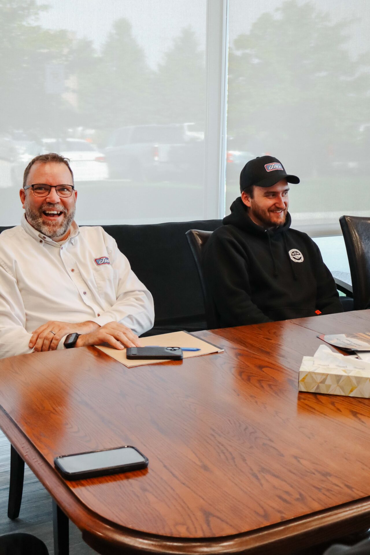 Joe's Heating team sitting in office