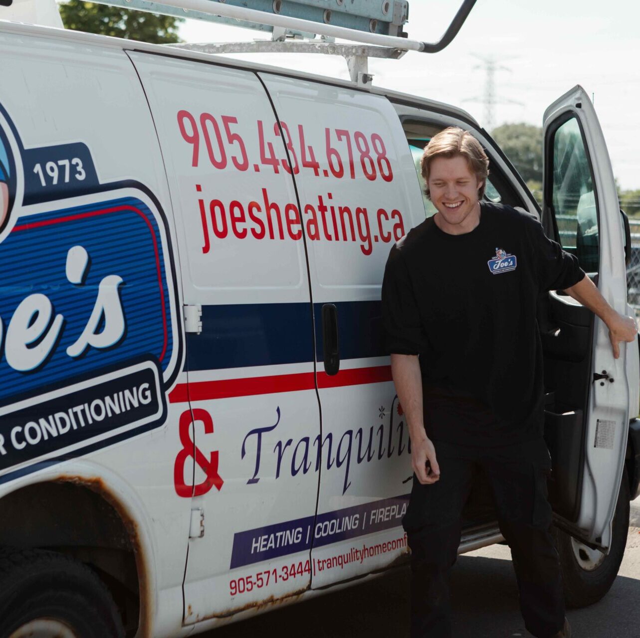 Joe's Heating technician getting out of company truck