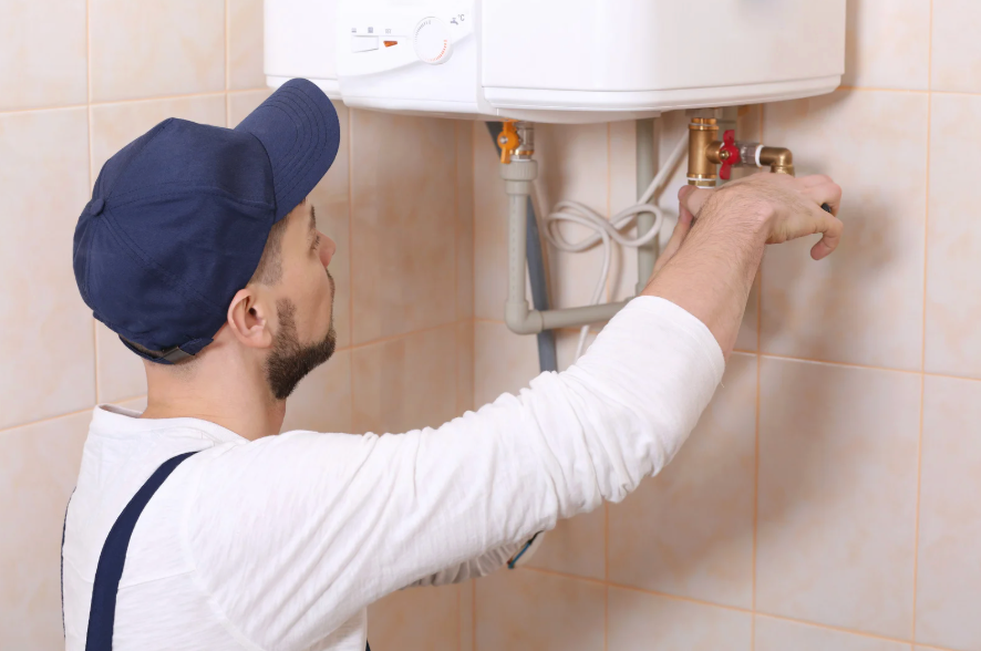 HVAC technician servicing a boiler in a home