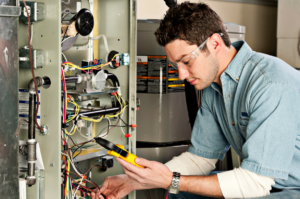 Technician inspecting a furnace