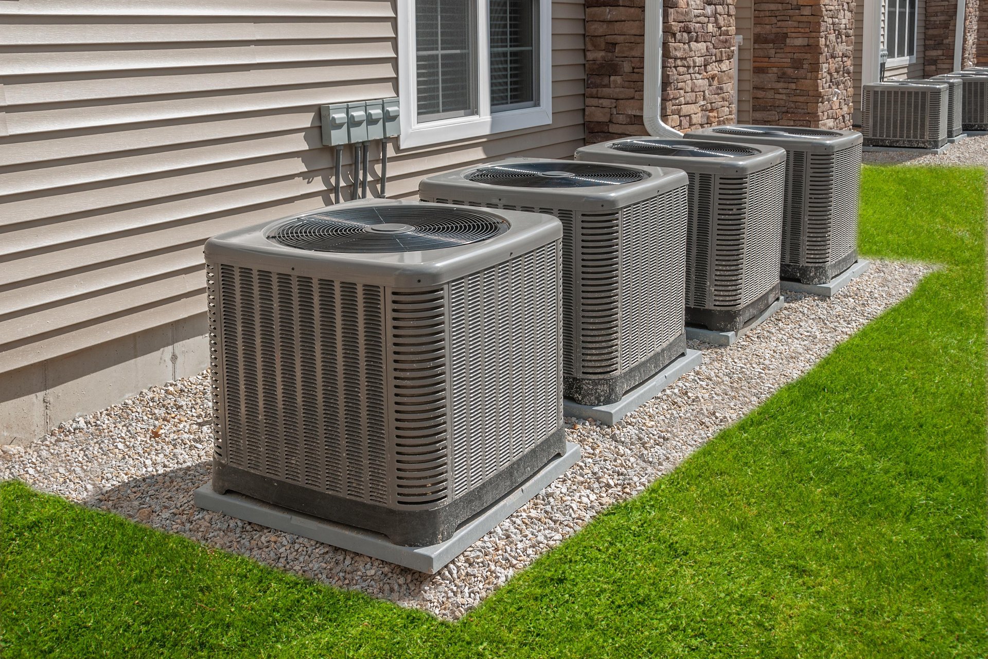 Four air conditioning units outside along building